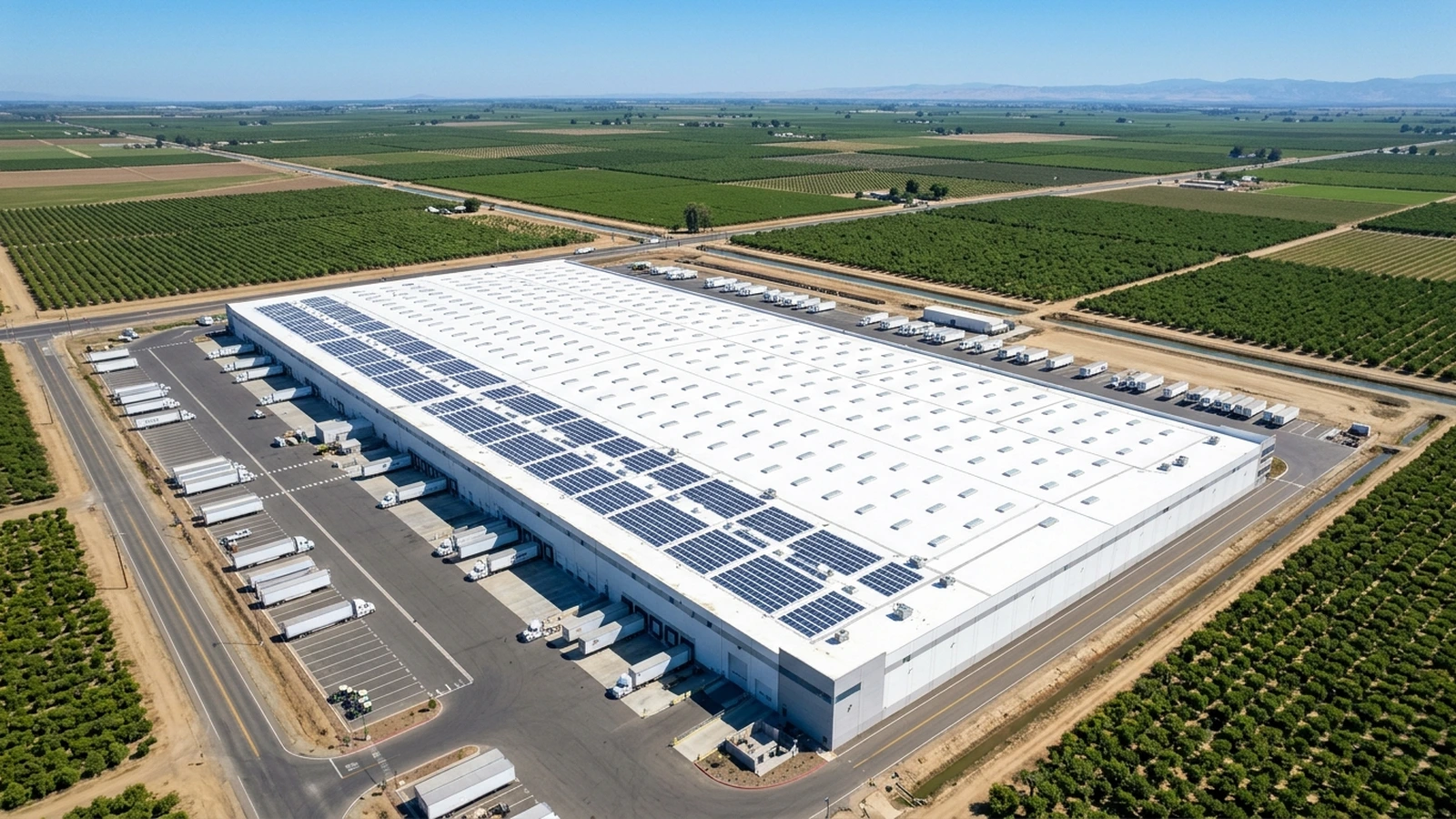 Overhead view of a flat-roofed warehouse with skylights and solar mounting rails, Madera